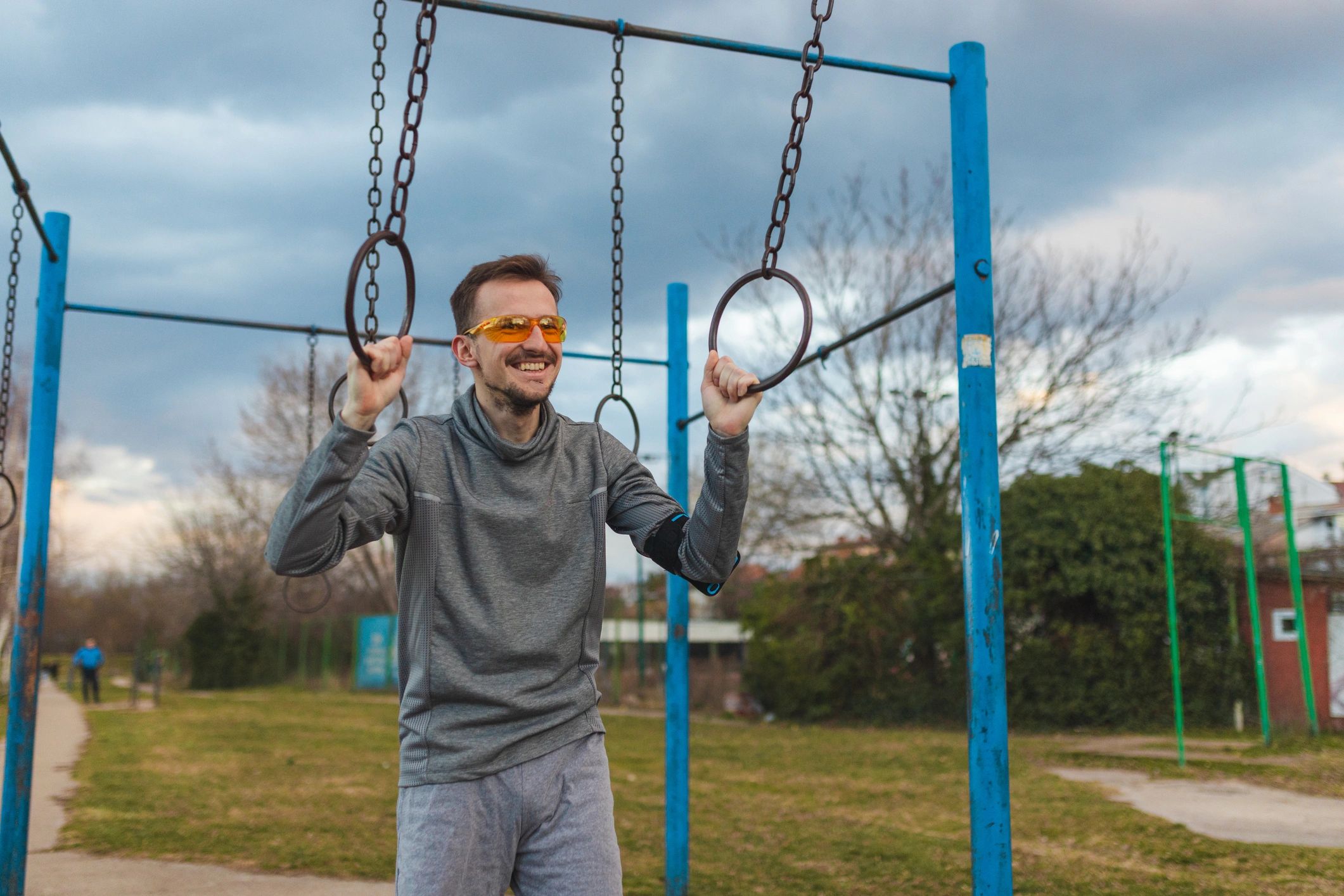 Client portrait outdoors near gymnastics rings