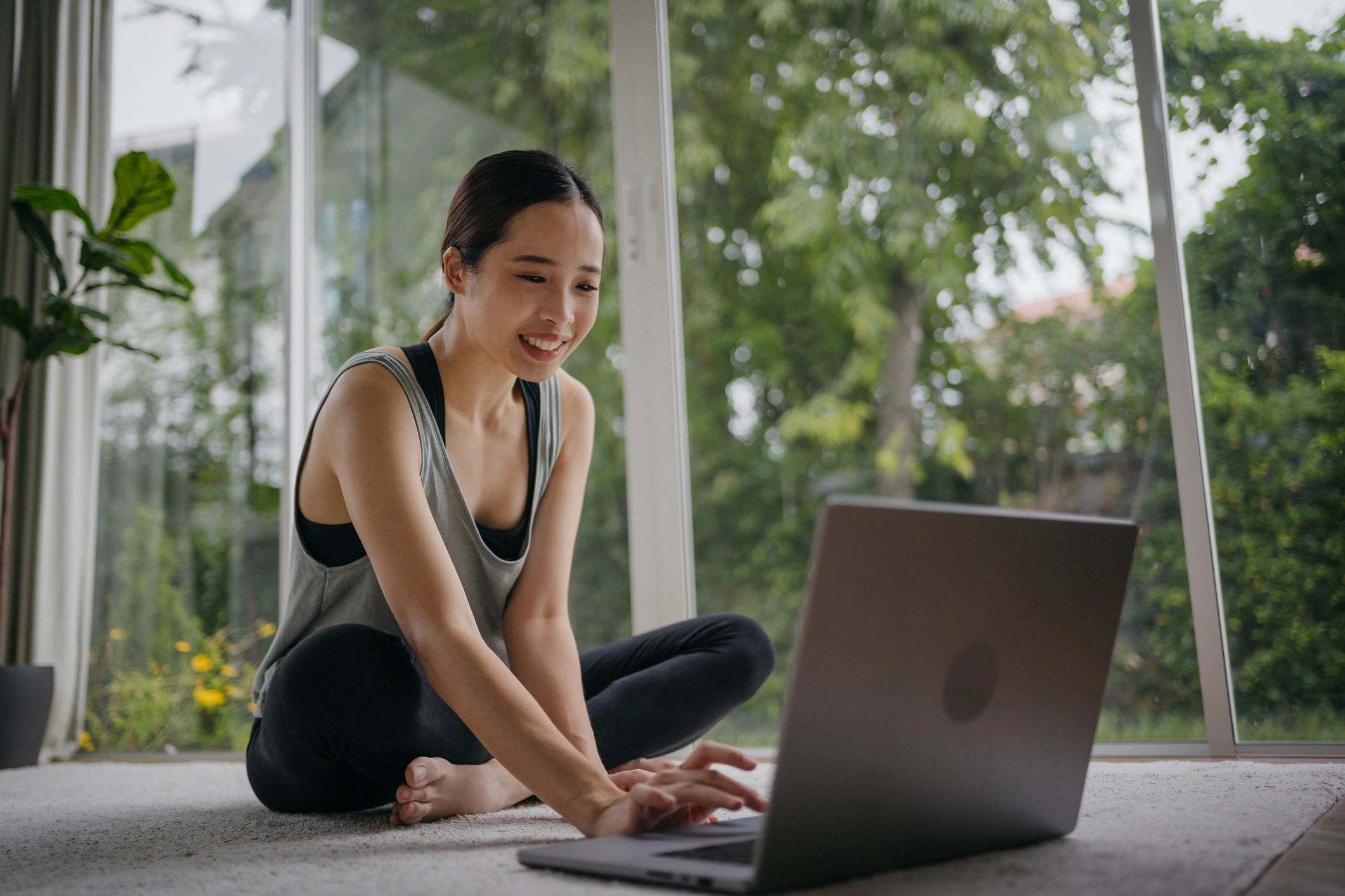 Client preparing for an online fitness coaching session on a laptop