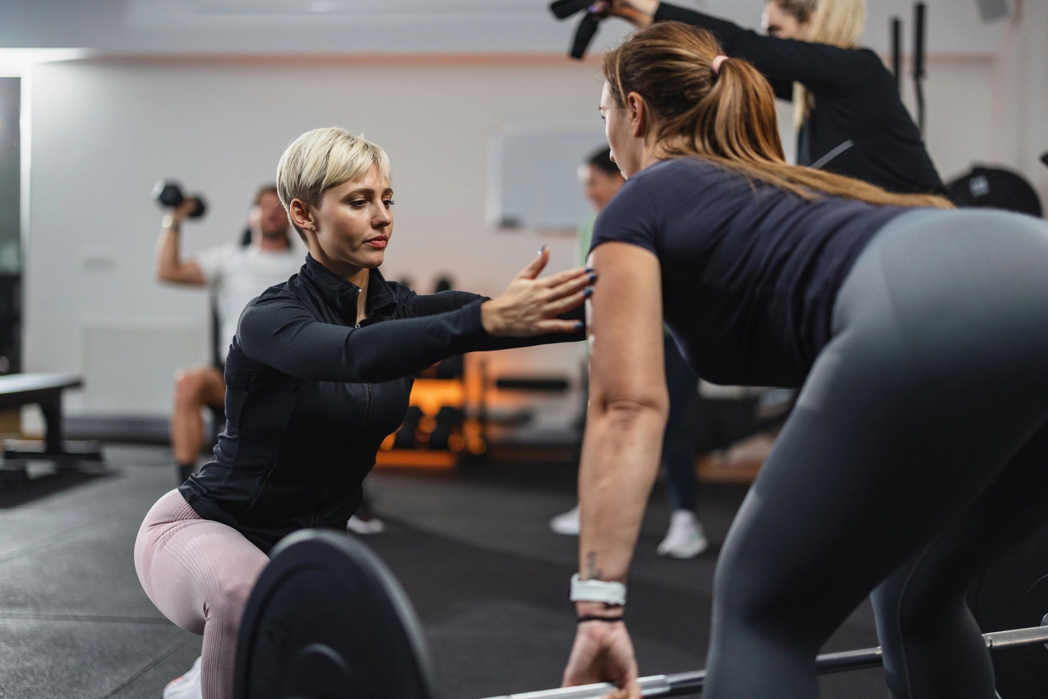 Personal trainer coaching a client during strength training