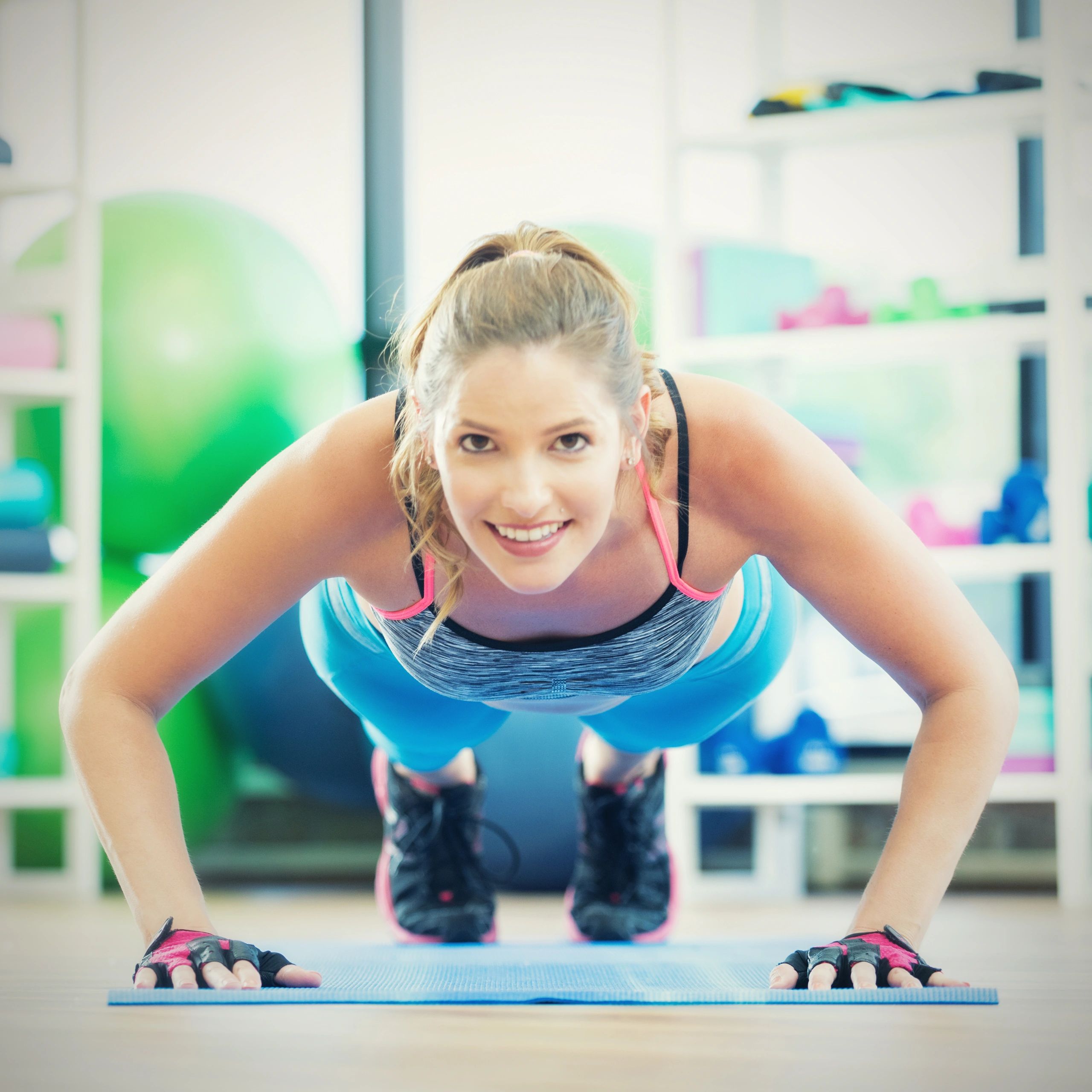 Woman doing push-ups on a mat